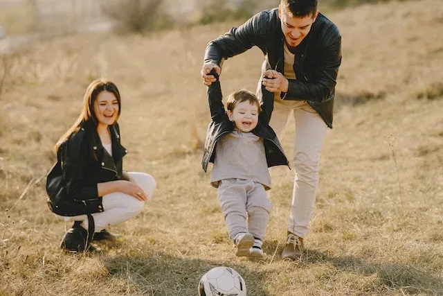 A couple playing with their child - indicating joy